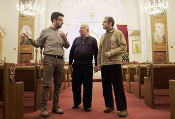 Syrian Armenian Newcomers, Ohannes Tchamichian (left) and Vanig Garabedian (right) talk about successes and challenges of the last year with Apkar Mirakian, who is in charge of the Armenian Community Centre's Syrian refugee resettlement program in the Armenian Church on Wednesday, Dec. 28. (Photo: Justin Greaves/Metroland)