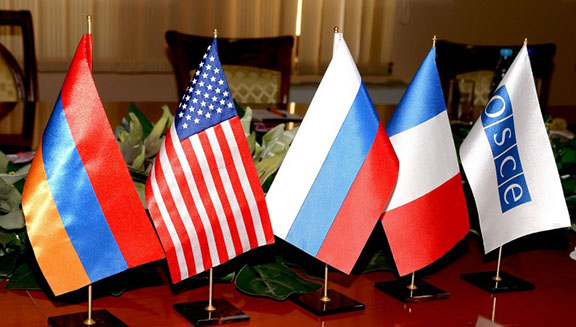 (From left to right) Armenian flag, flags of the OSCE Minsk Group Co-Chair representing countries (USA, Russia, France), and the OSCE flag