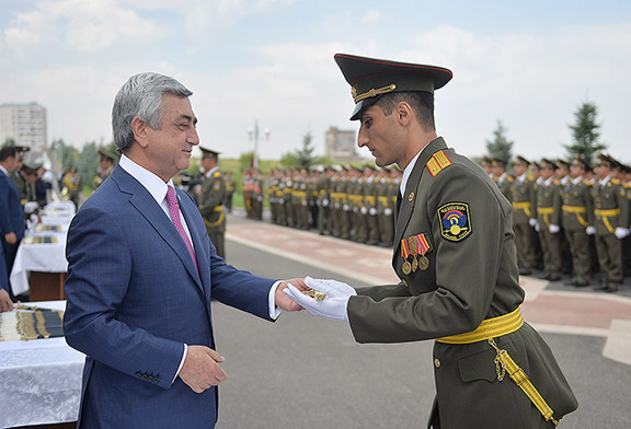 President Serzh Sarkissian awards a graduate of Armenia's Military Institute a dagger (Source: Office of the President of the Republic of Armenia)