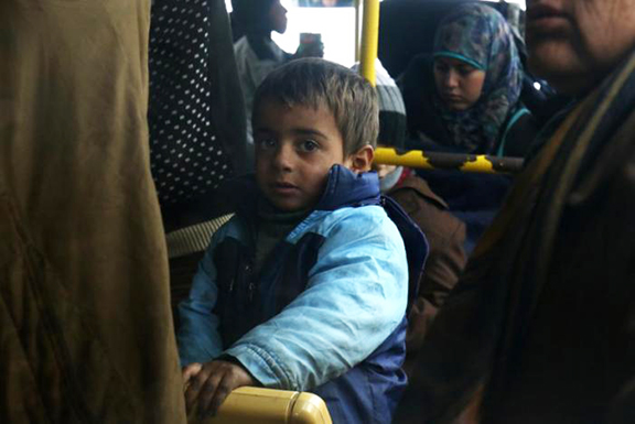 Evacuees from the Shi'ite Muslim villages of al-Foua and Kefraya ride a bus at insurgent-held al-Rashideen in Aleppo province, Syria Dec. 22, 2016. (Reuters/Ammar Abdullah)