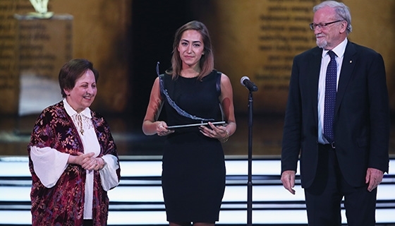 Michela Catena, the niece of Aurora Prize finalist Dr. Tom Catena, accepts the award on his behalf (Photo: Aurora Prize)