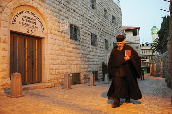 A priest walks through one of the street’s in Jerusalem’s Armenian Quarter. (Photo: Matthew Karanian)
